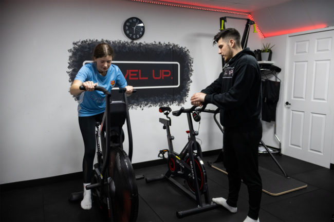 Client on an exercise bike with Instructor supervising