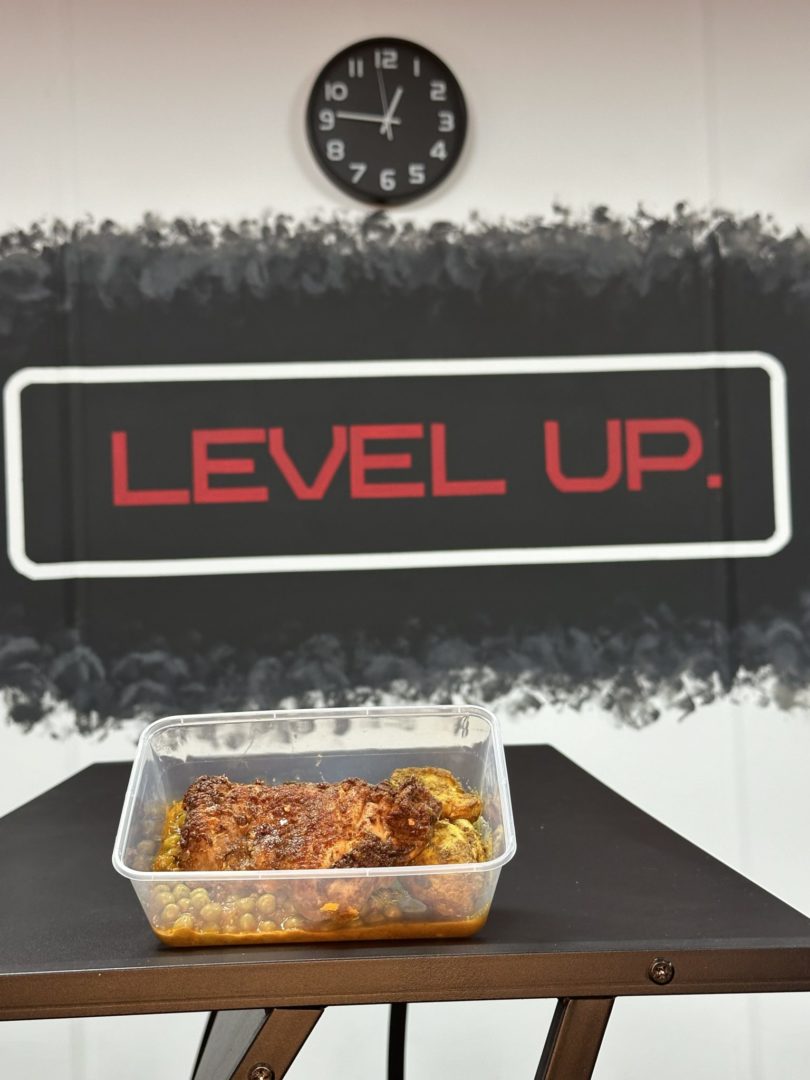 Ras El Hanout Chicken Curry, with the level up logo behind the food
